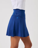 Blue skirt worn by a person on a white background