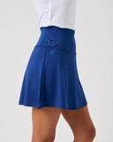 Blue skirt worn by a person on a white background