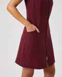 Maroon dress worn by a person on a light gray background