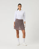 Woman wearing a white shirt and brown skirt on a white background