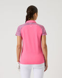 Woman wearing a pink polo shirt with patterned sleeves on a white background