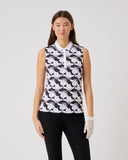Woman wearing a sleeveless patterned top and black pants on a white background
