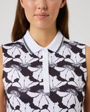 Woman wearing a sleeveless top with black and white floral pattern