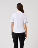 Person wearing a white polo shirt and black pants on a light gray background