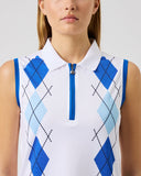 Person wearing a white sleeveless shirt with blue argyle pattern on a plain background