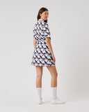 Person wearing a patterned dress on a white background