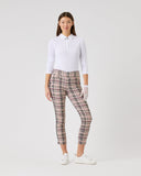 Woman wearing a white shirt and plaid pants on a white background