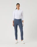 Woman wearing a white shirt and blue polka dot pants on a white background