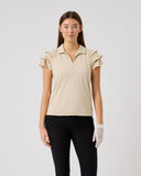 Woman wearing a beige polo shirt and black pants on a white background
