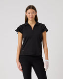 Woman wearing a black outfit with gloves on a light gray background