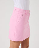 Pink skirt worn with a white top on a plain background