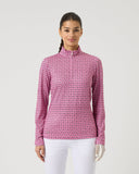 Woman wearing a pink patterned long-sleeve shirt on a white background