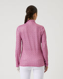 Woman wearing a pink patterned shirt on a white background