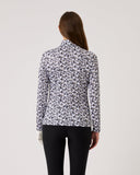 Woman wearing a floral patterned blouse against a plain background