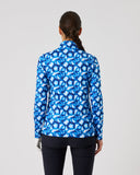 Person wearing a blue patterned jacket on a gray background