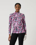 Woman wearing a pink and black patterned long-sleeve top on a white background