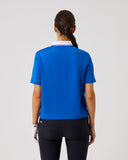 Person wearing a blue shirt and black pants on a light gray background