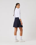 Person wearing a white shirt and navy skirt on a light gray background