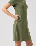 Green dress worn by a person on a light gray background