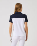 Person wearing a black and white polo shirt on a plain background