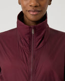 Maroon jacket worn by a person on a light gray background