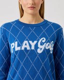 Blue sweater with 'PLAY GOLF' text worn by a person on a light gray background