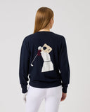 Person wearing a navy blue sweatshirt with a graphic design on the back, standing against a plain background.