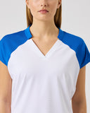 Woman wearing a white and blue shirt on a plain background