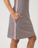 Woman wearing a patterned dress with a white background
