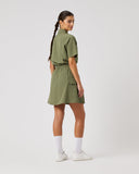 Woman wearing a green dress on a white background