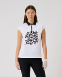 Woman wearing a white sleeveless shirt with black pattern on a plain background