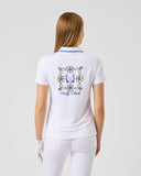 Woman wearing a white polo shirt with a logo on the back against a light gray background