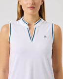 Woman wearing a white sleeveless polo shirt with a small logo on a light gray background