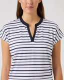 Woman wearing a black and white striped shirt against a plain background