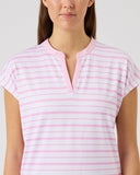 Woman wearing a pink and white striped shirt against a plain background