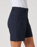 Navy shorts worn by a person on a light gray background
