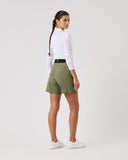 Person wearing a white long-sleeve shirt and green shorts on a white background