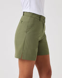 Green shorts worn by a person on a white background