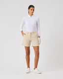 Person wearing a white shirt and beige shorts on a plain background