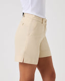 Beige shorts worn by a person on a white background