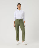 Woman wearing a white shirt and green pants on a white background