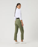 Person wearing a white shirt and green pants on a white background
