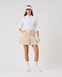 Woman in golf attire on a white background