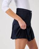Person wearing a navy blue skirt with a white background