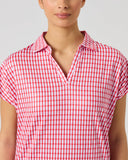 Daily Sports Sunny Geo Printed Air Cap Sleeve Polo close-up of hot pink and white geometric grid print featuring repeating linked square motifs with open V-neck polo collar and cap sleeve detai