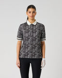 Daily Sports Zebra Print Half Sleeve Polo Shirt in black and white abstract zebra swirl print – women's half sleeve golf polo with cream contrast collar, button placket and striped cuff trim, front view on mode