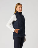 Women's reversible solid dark navy padded golf vest with zipped side pocket and quilted padding – solid side angled view
