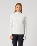 A woman modeling a white long-sleeve quarter-zip pullover top with a mock neck, paired with dark navy leggings, against a solid light gray studio background.