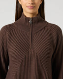 Close-up of women's brown ribbed wool blend golf pullover with half zip, high collar, and Daily Sports branded zipper pull
