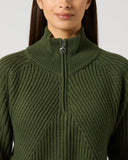Close-up of women's khaki green ribbed wool blend golf pullover with half zip, high collar, and Daily Sports branded zipper pull
